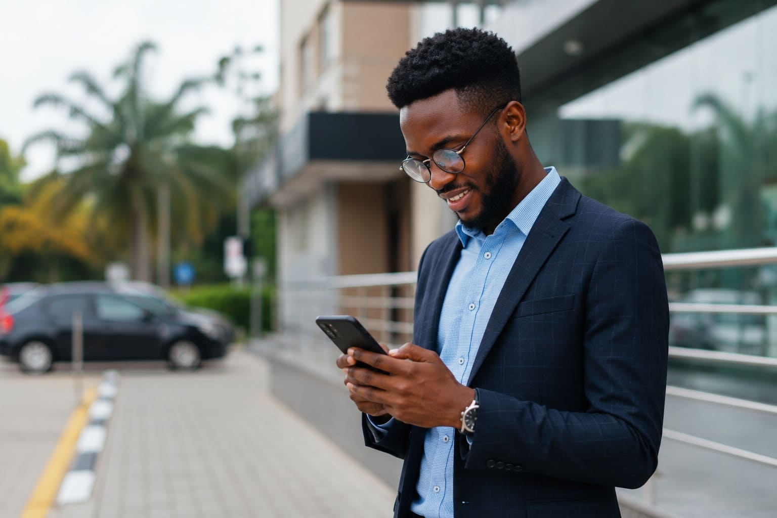 A young professional smiling at their phone